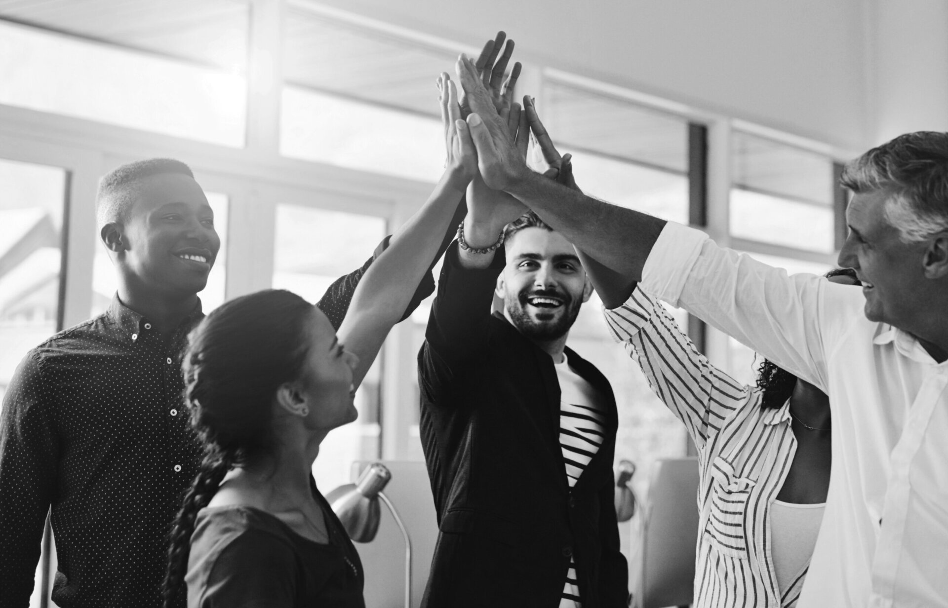 Corporate businesspeople celebrate success in an office. Passionate people feeling motivated