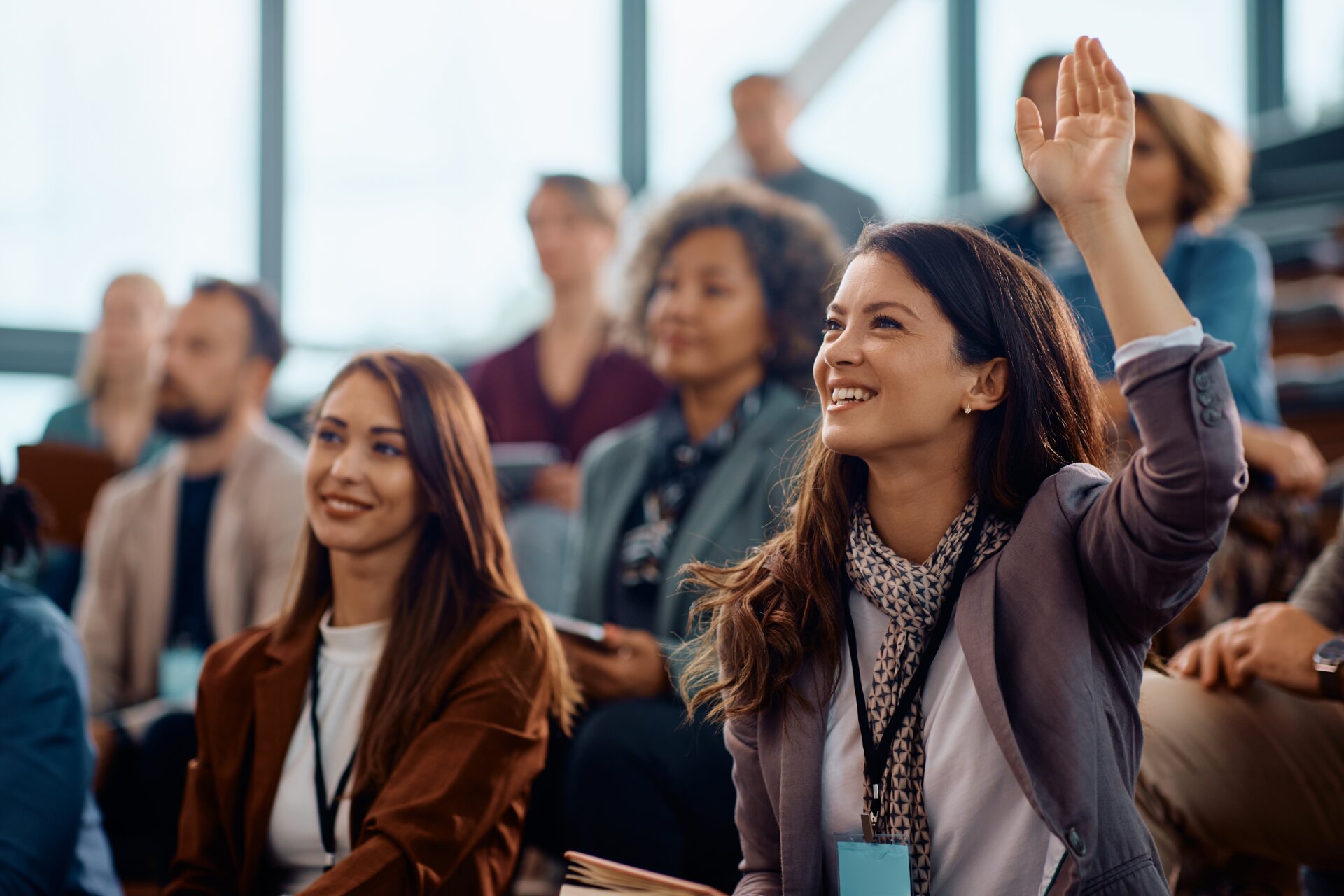 Happy,Businesswoman,Raising,Hand,To,Ask,A,Question,Attending,A